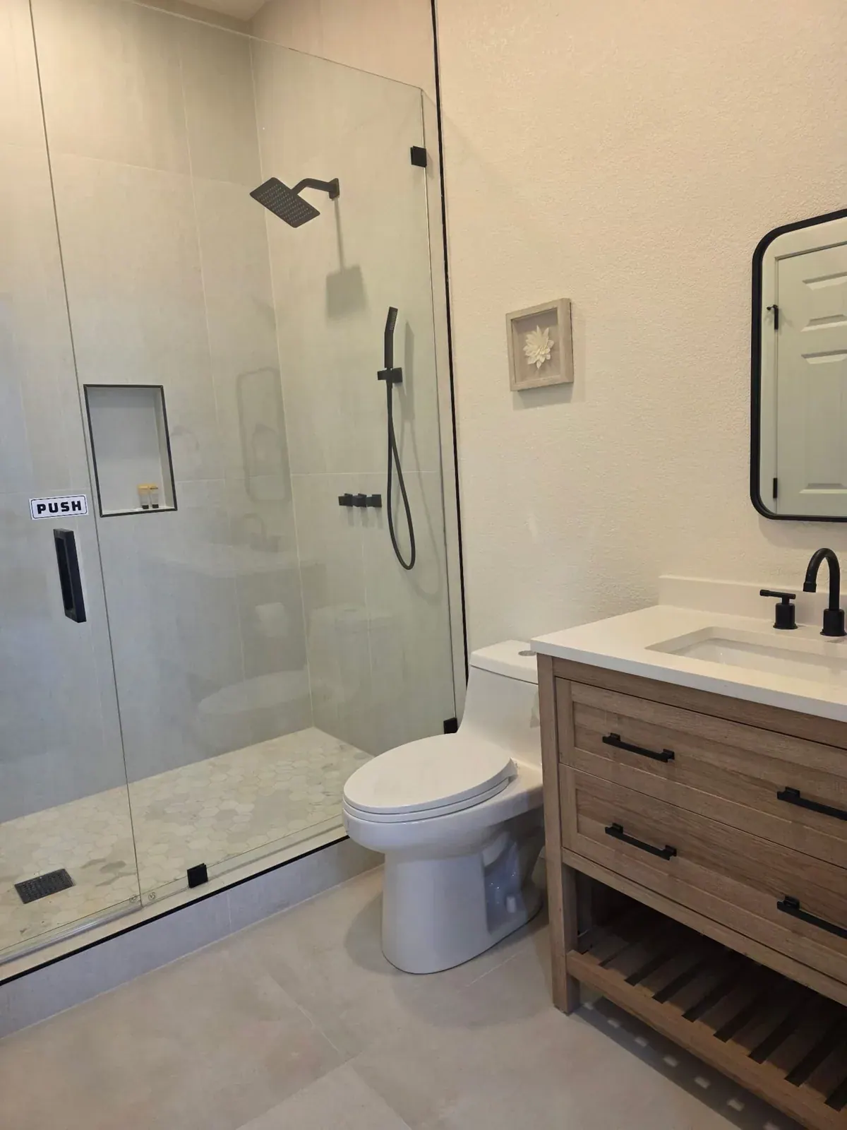 Full bathroom with a wide walk-in shower and oak vanity