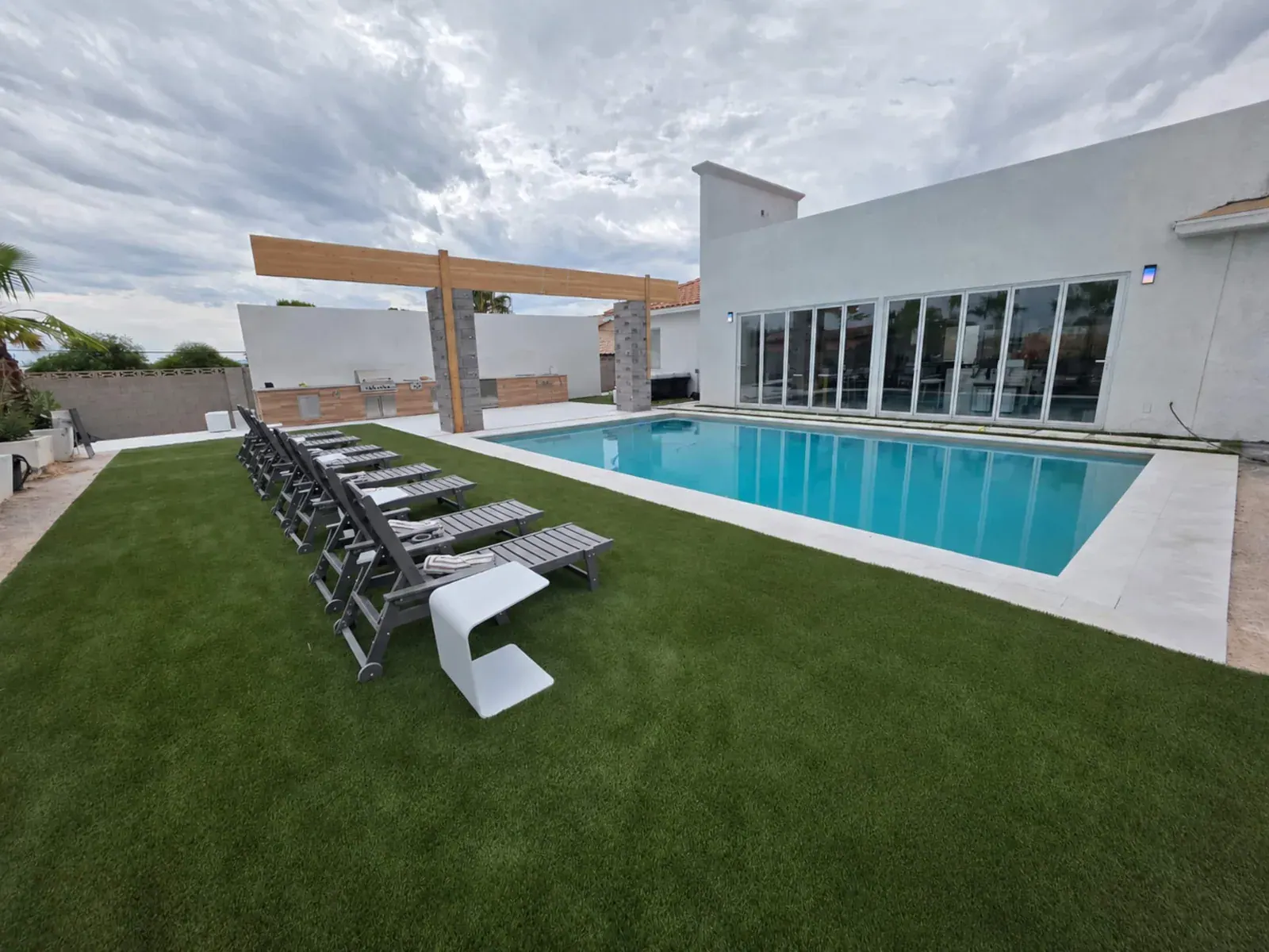 Outdoor lounging area beside the pool