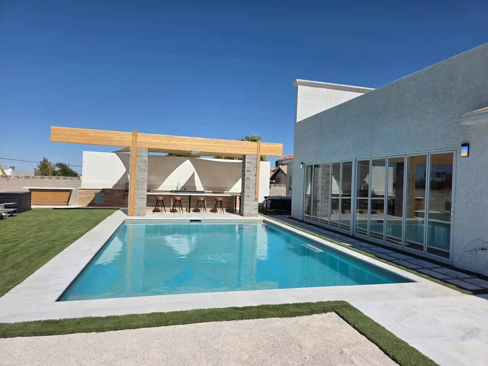 Heated pool and shaded outdoor kitchen at a private Las Vegas villa