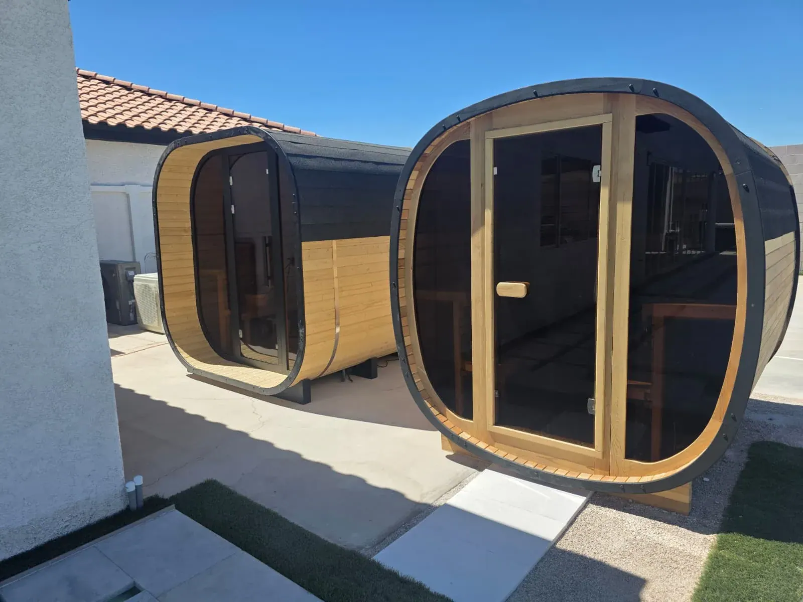 The two cedar barrel saunas side by side on the deck