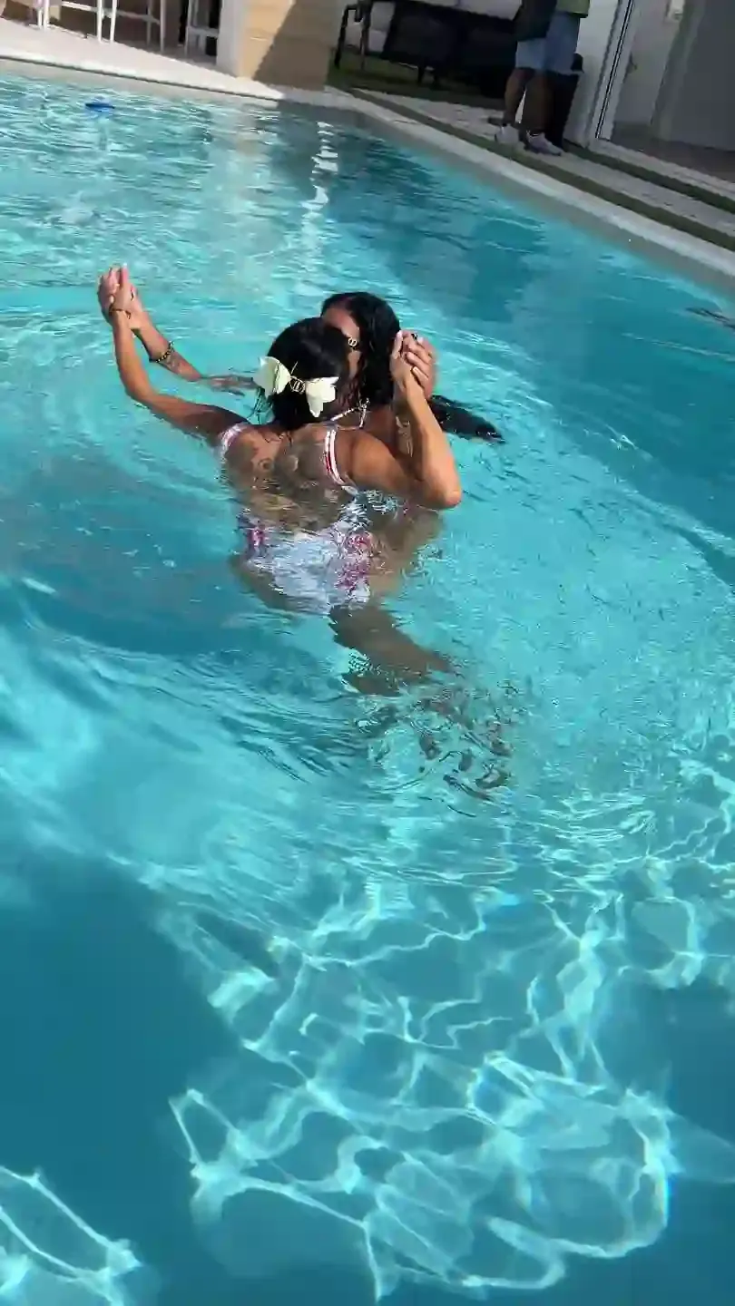 Two guests in the pool, mid-afternoon
